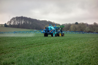Photograph of a tractor spraying fertilizer on a field Photograph of a tractor spraying fertilizer on a field