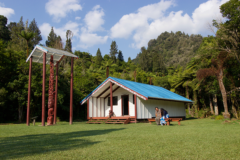 Blue-roofed marae nestled among New Zealand native bush Blue-roofed marae nestled among New Zealand native bush