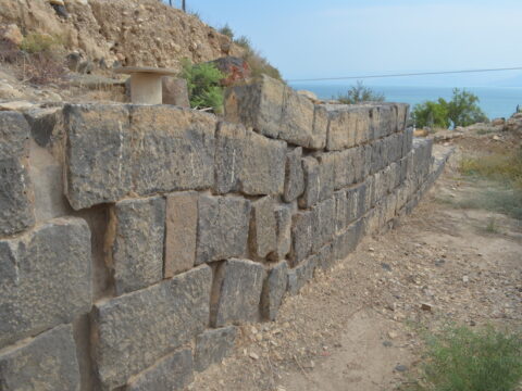 An ancient Roman wall’s masonry blocks are warped.