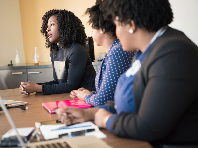 Women working on laptops at a business meeting