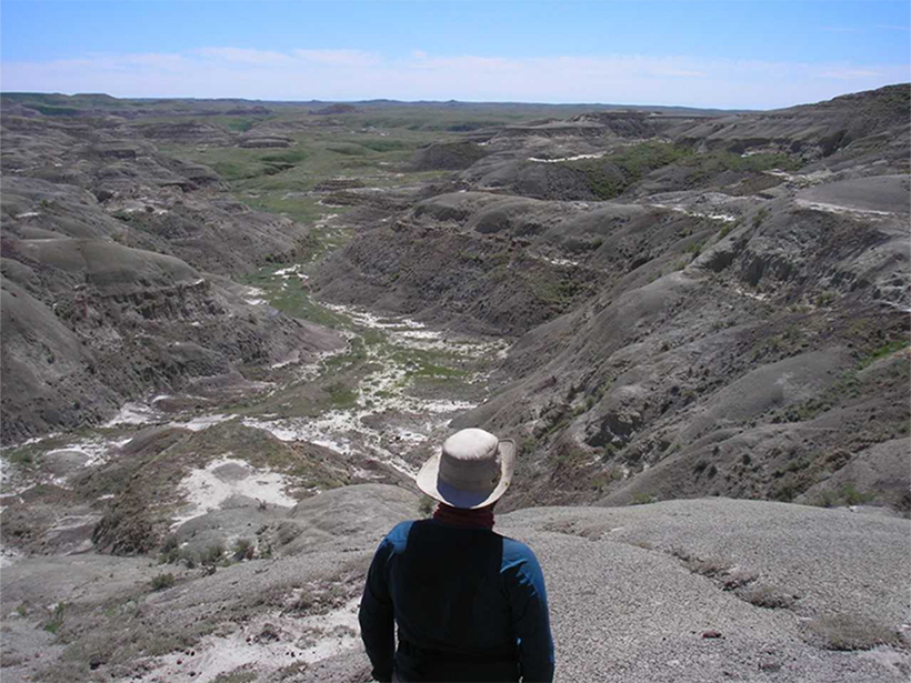 A researcher looks over Frenchman Valley, Chambery Coulee, Saskatchewan.