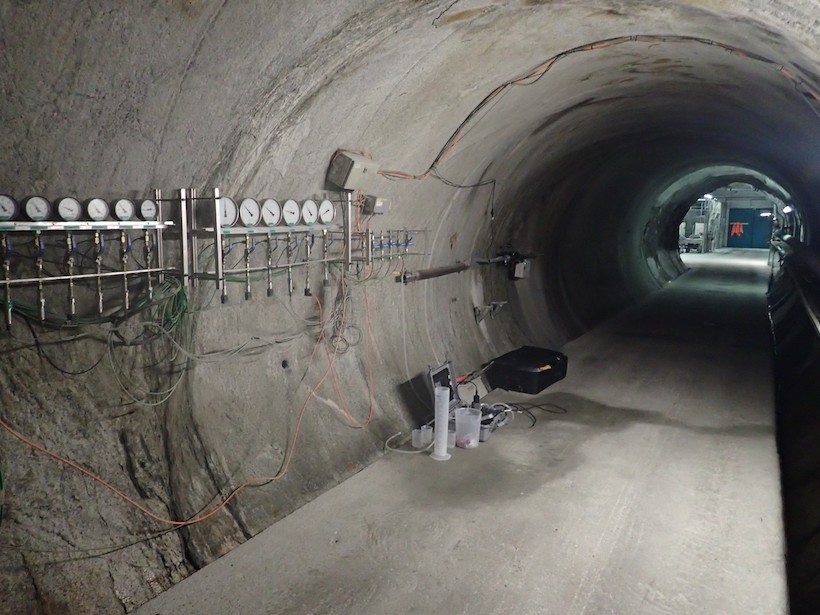 View looking down an underground tunnel with various gauges and water sampling equipment visible