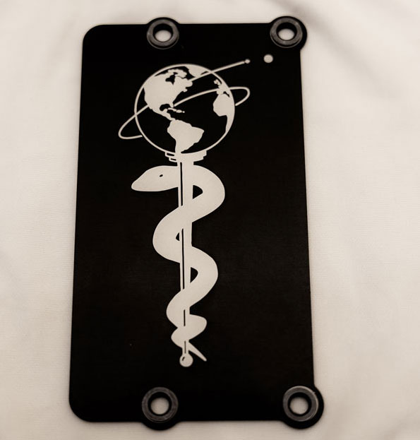 A metal plate with a caduceus carried on the Perseverance rover