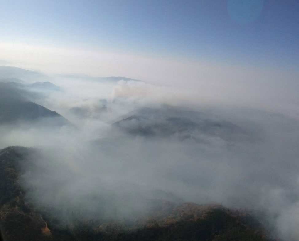 Areal view from a helicopter of smoke from the Camp Fire hovering over the landscape