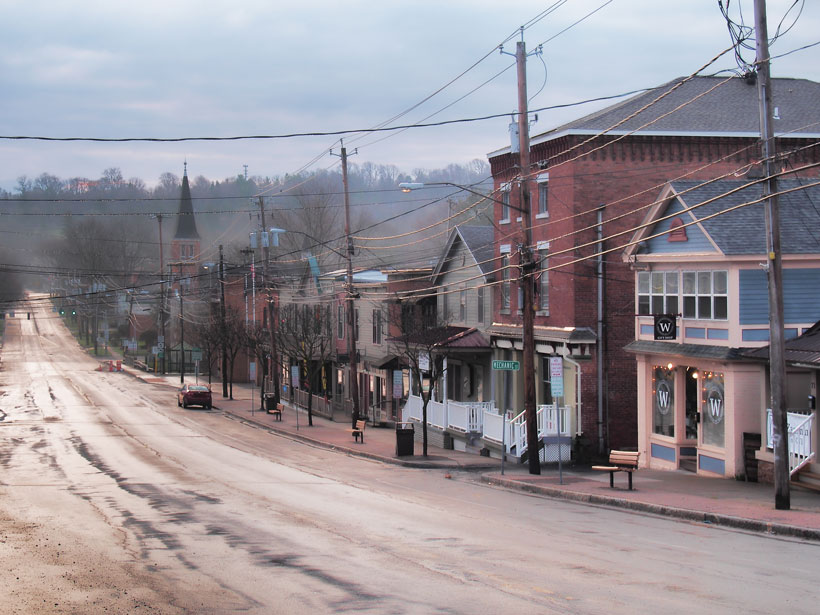 Shops line a street running through a small town in upstate New York.