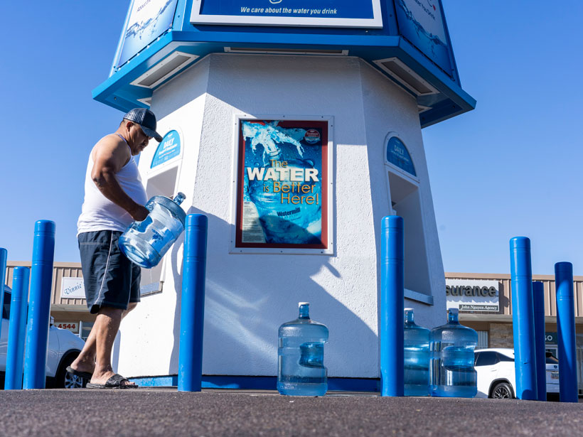 Jaime Elizondo fills up a bottle of water in west Phoenix. Jaime Elizondo fills up a bottle of water in west Phoenix.