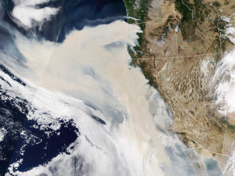 Satellite image showing smoke spreading from numerous fires near the U.S. West Coast