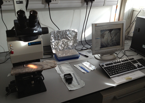 Lab bench with a computer and an instrument used to drill small samples from speleothems Lab bench with a computer and an instrument used to drill small samples from speleothems