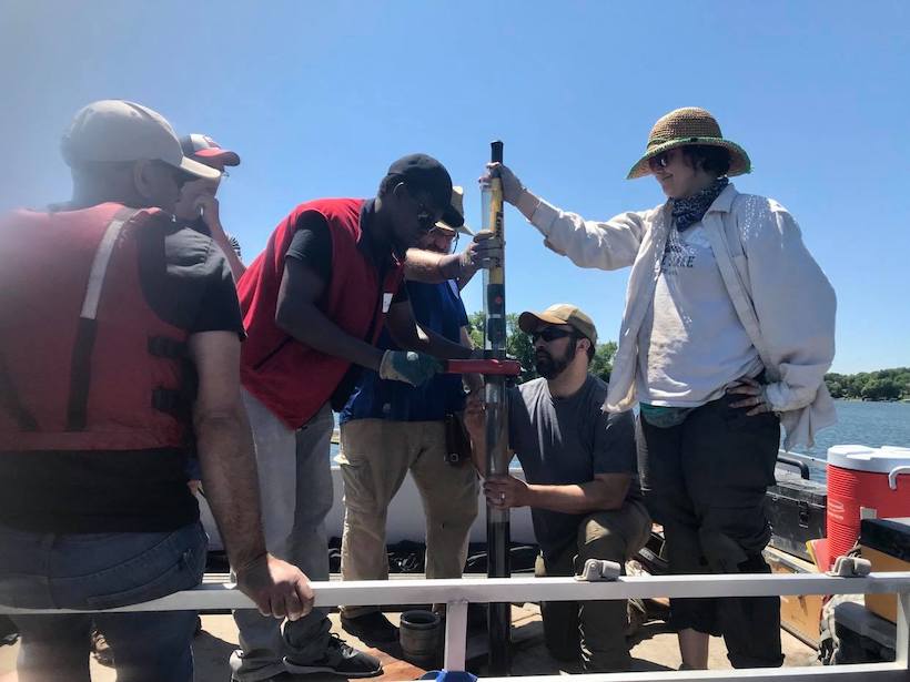 Paleolimnologist Tumaini Kamulali takes core samples on Sweeney Lake in Minnesota.