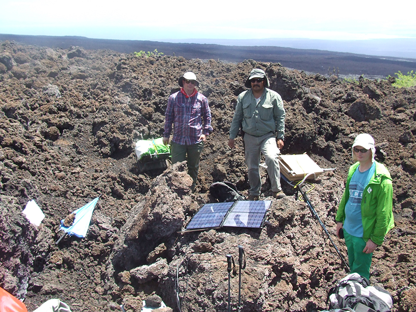 A group of researchers attend to seismic instruments at Sierra Negra in the Galápagos.