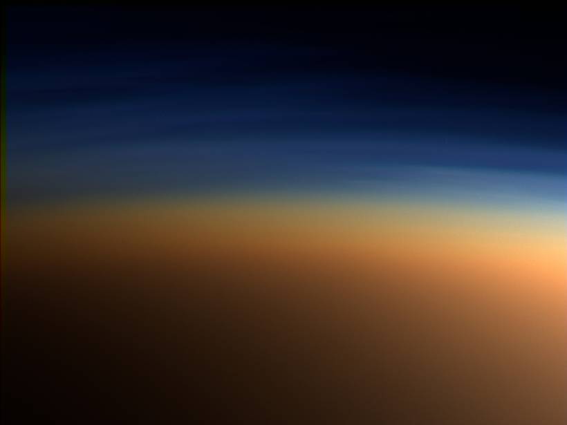 Layers of black, blue, and orange haze in Titan’s atmosphere