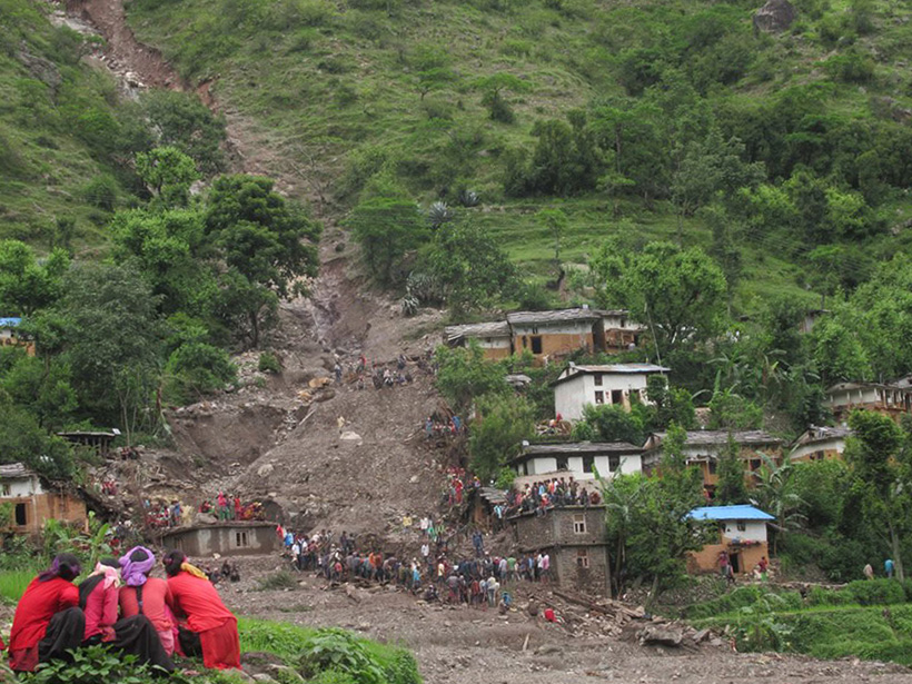 Debris from a large landslide is heaped amid a damaged community in western Nepal