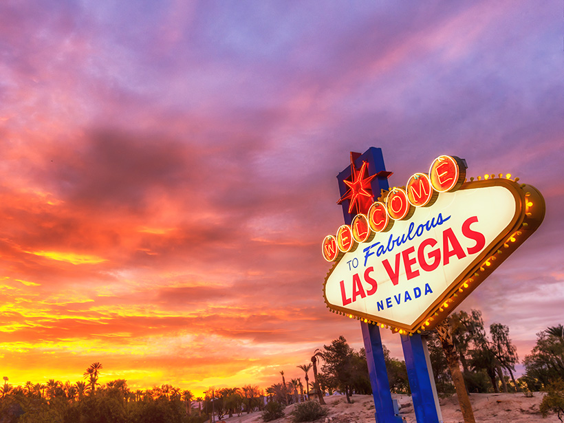 “Welcome to Fabulous Las Vegas” sign against a backdrop of desert flora