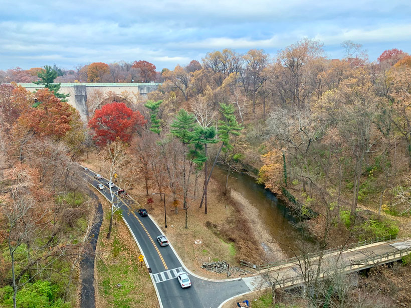 Cars drive through Rock Creek Park in Washington, D.C., as seen from a bridge.