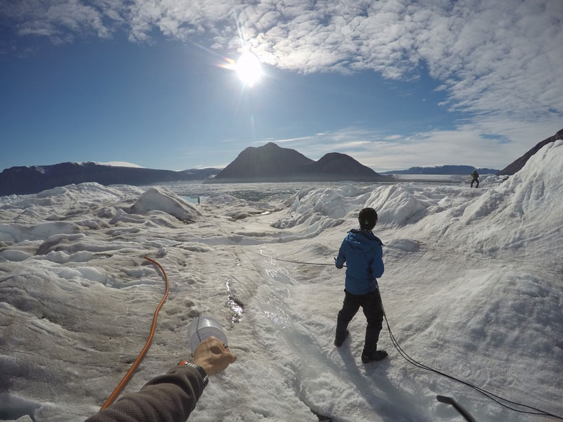 Three researchers with cables on ice