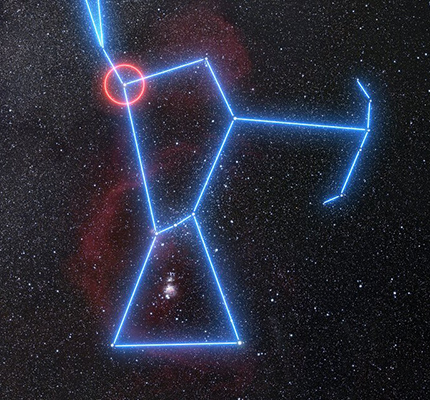 The stars of the constellation Orion are connected by blue lines as they sit amid an image of the surrounding star field and nebulae. Betelgeuse, at Orion’s right shoulder, is circled in red.