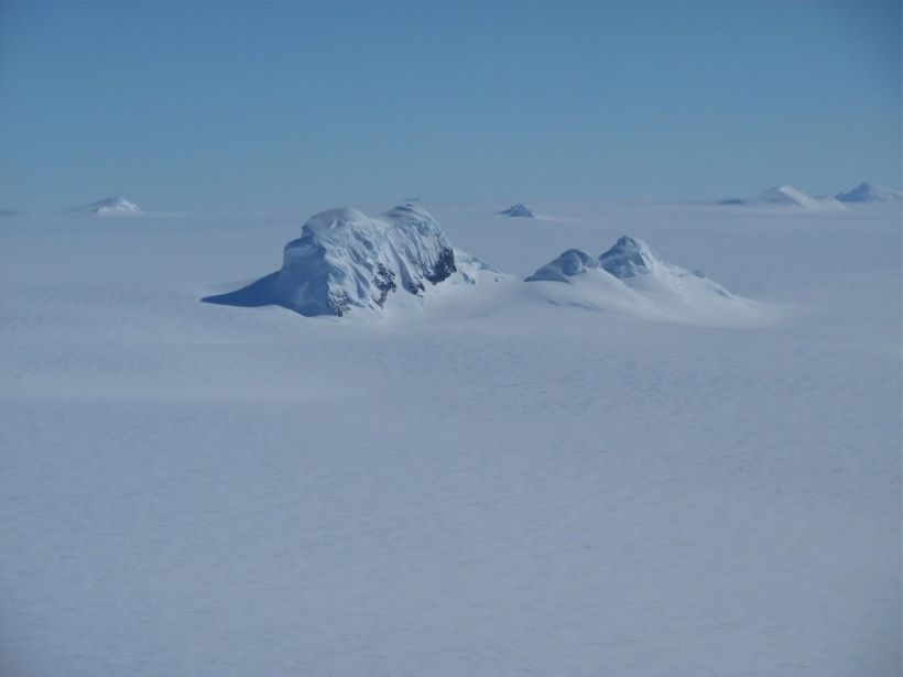 Mountain peaks through the ice cover on Thurston Island off of western Antarctica.