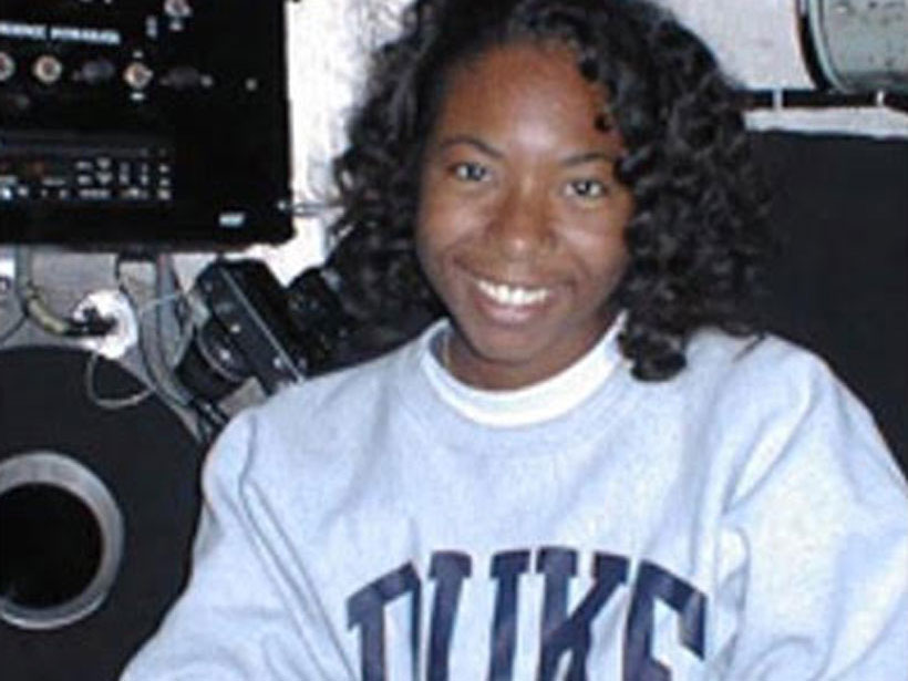 Aisha Morris smiles while perched in the Alvin submersible.