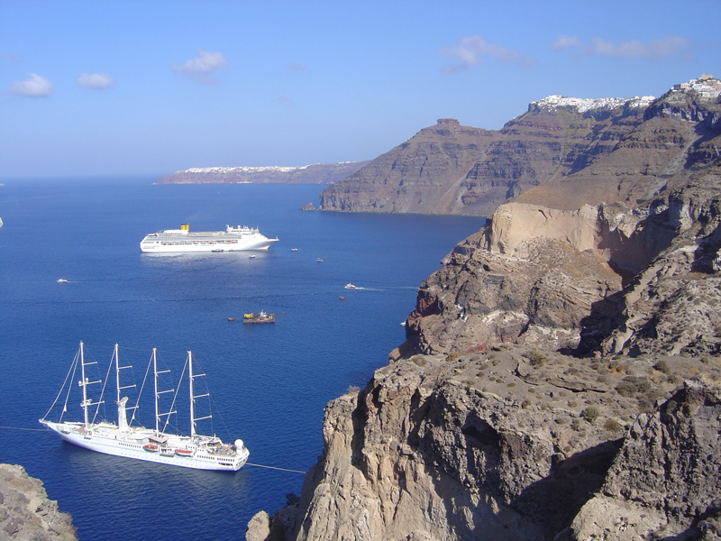 A photograph of the sheer cliffs of Santorini and the ocean below. A photograph of the sheer cliffs of Santorini and the ocean below.