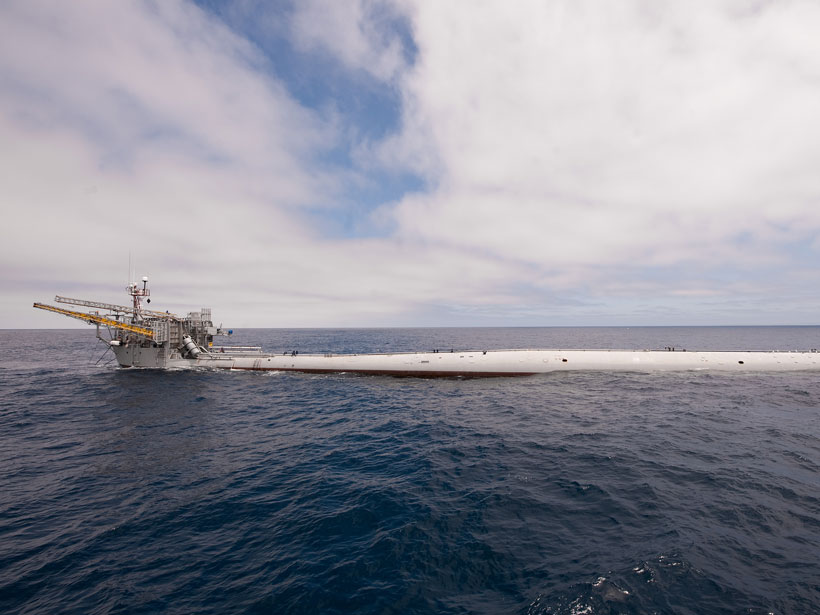 The long, tubular research platform FLIP lies horizontally at the ocean surface.