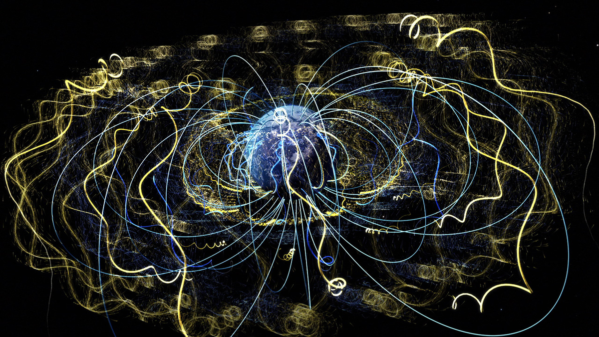 An artist’s conception of trapped electrons spiraling about magnetic field lines in Earth’s magnetosphere