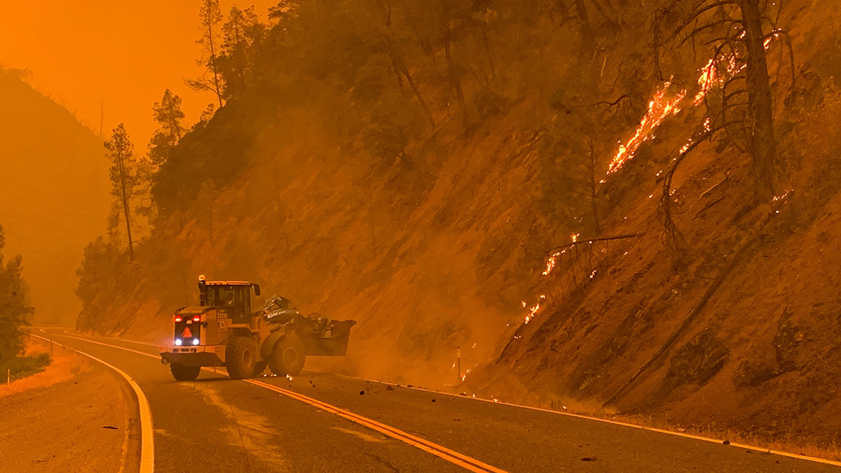 Bulldozer establishes a fire line near a highway in Trinity County, Calif.