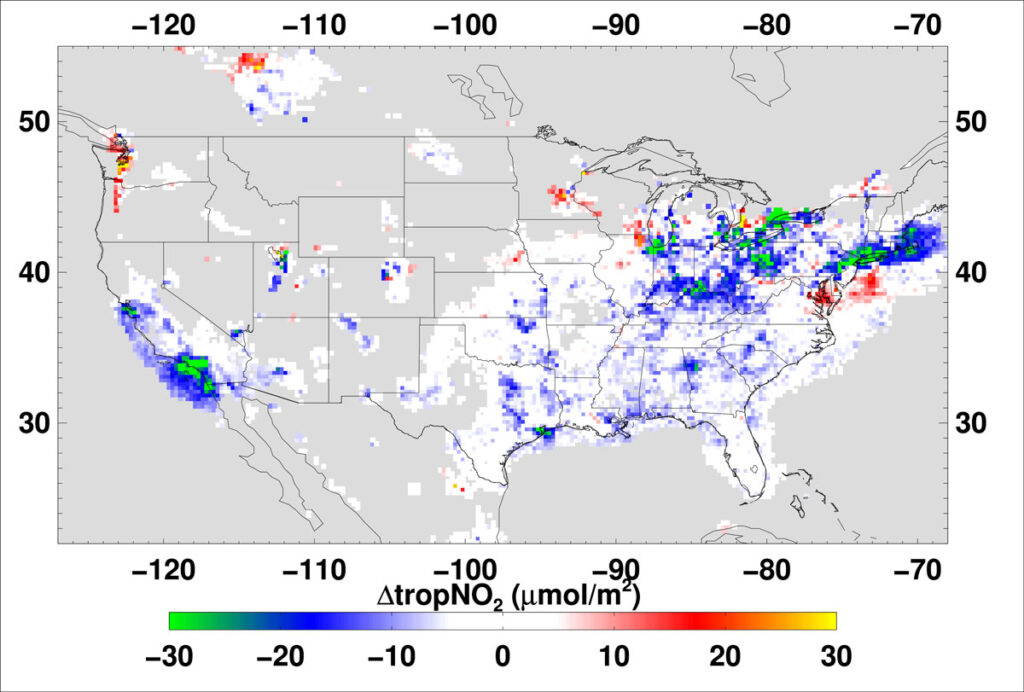 A gray map of the continental United States, with splotches of color ranging from green to yellow over primarily urban regions. A scale bar is at the bottom of the map, ranging from −30 to 30 micromoles per square meter of change in tropospheric NO2.