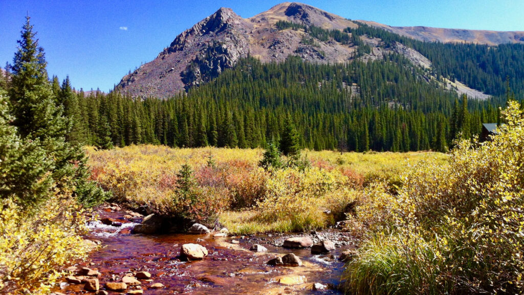This junction in Colorado’s Snake River is tinged with orange due to acid rock drainage.