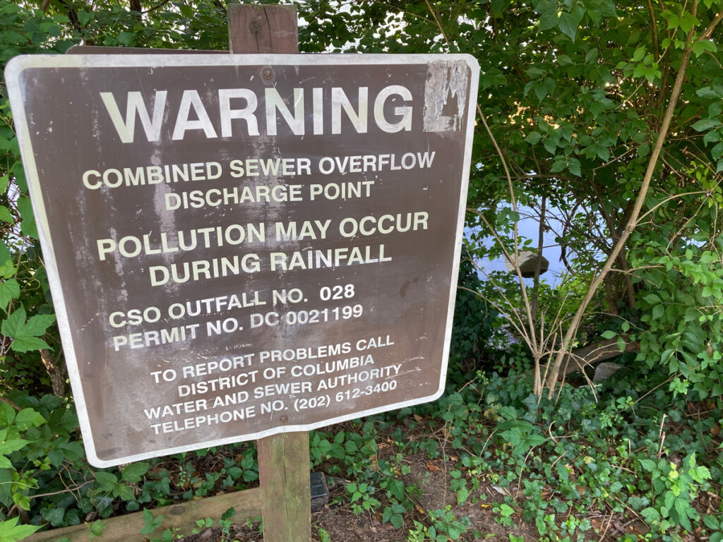 A sign warns residents of potential sewage overflows.