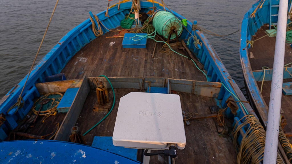 Skylo Hub, a modem-sized piece of hardware, on a boat at sea