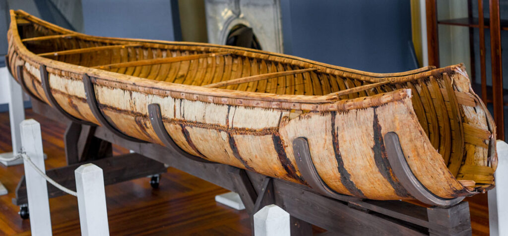 Museum exhibit of a birchbark canoe used by the Wabanaki people of Maine.