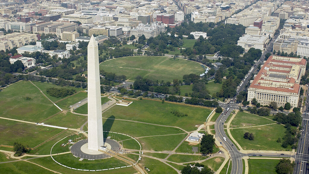 Aerial view of the Washington Monument and the White House, with city buildings in the background