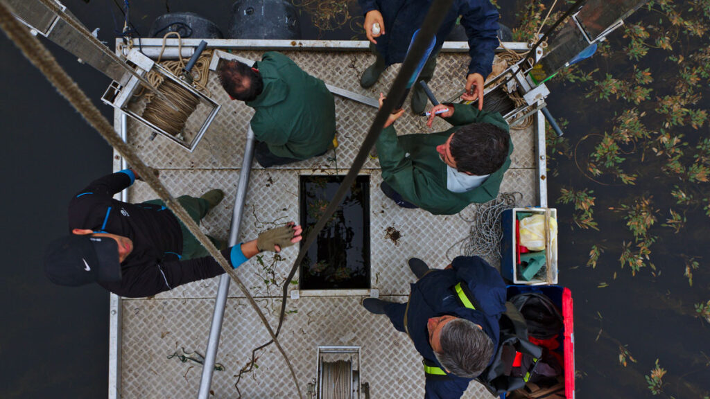 Overhead perspective of the team working and collecting data from the raft.
