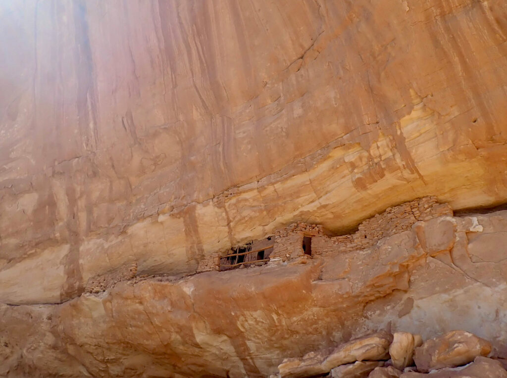 A collection of rock slabs, mud, and wooden sticks on a hard-to-reach ledge in Bears Ears.