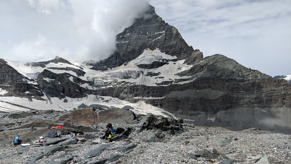 Researchers installing the reference station in a glacier forefield at the foot of the Matterhorn
