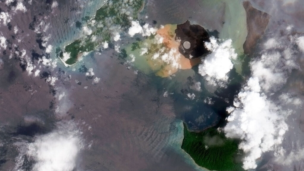 Satellite image of Anak Krakatau, Indonesia, with one slope covered in sediment.