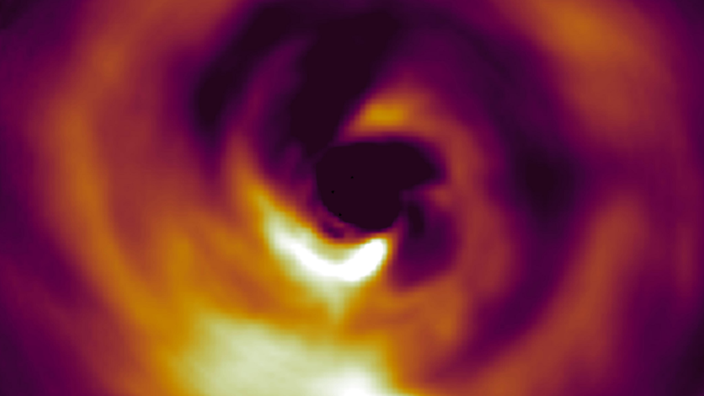 Image of AB Aurigae’s protoplanetary disk shows wispy spirals and a bright blobby protoplanet. A scale shows that the protoplanet’s orbit is about 3 times wider than Neptune’s orbit around the Sun.