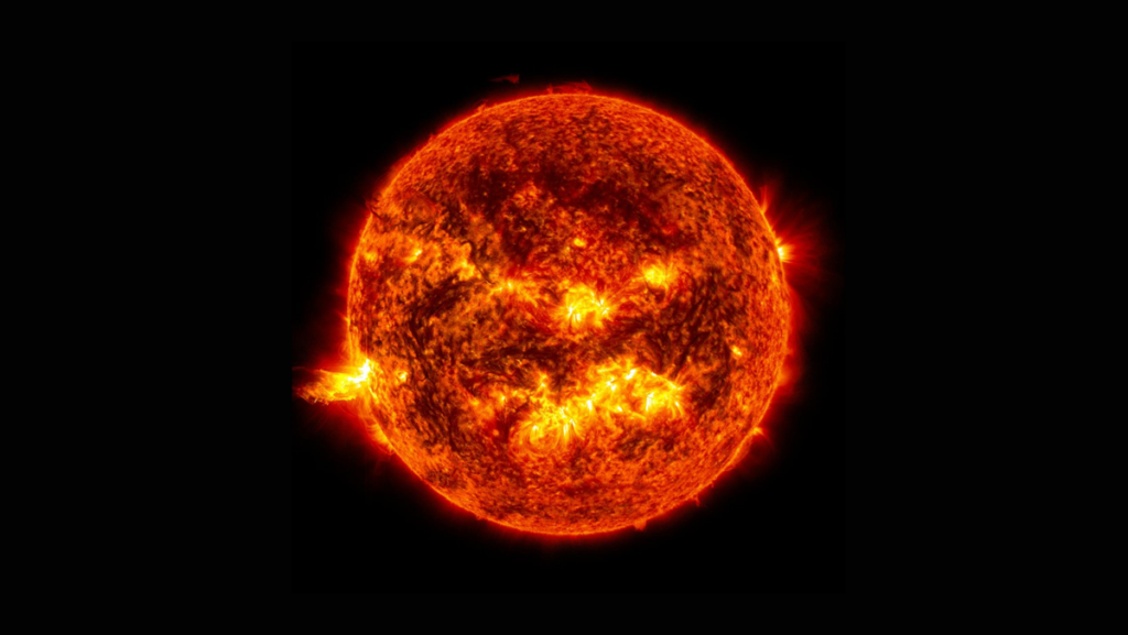 An image of the Sun showing an eruption of solar material from the Sun’s left side.
