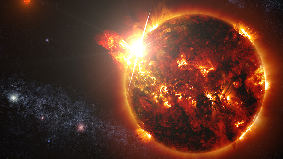 A poof of red and yellow light shoots out of a dark red and black star