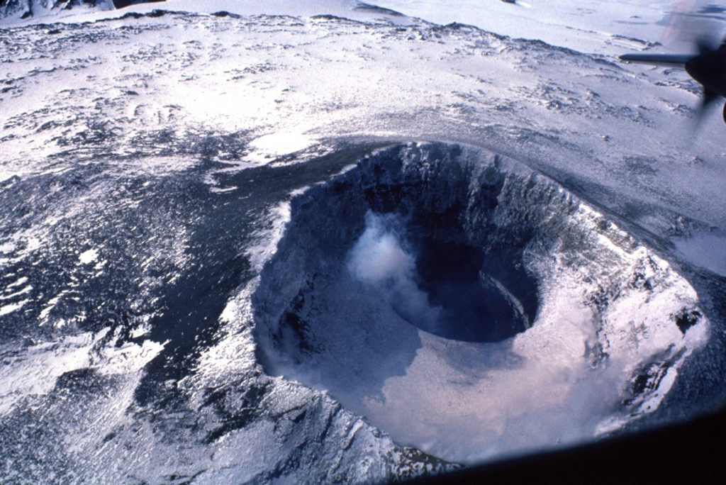 A close-up photograph of the crater at the top of Mount Erebus shows a plume rising from the small lava lake.