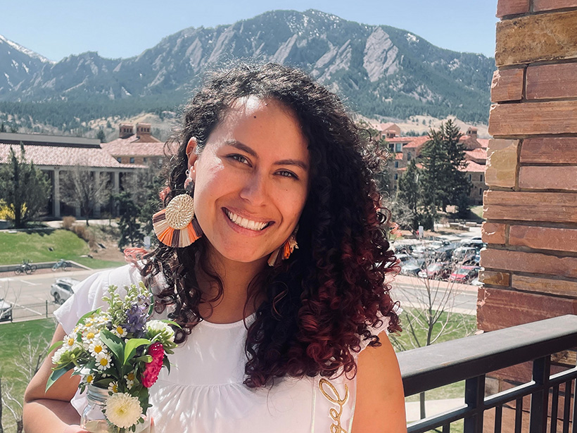 Lina Pérez-Ángel smiles from a balcony in front of the Colombian Andes.