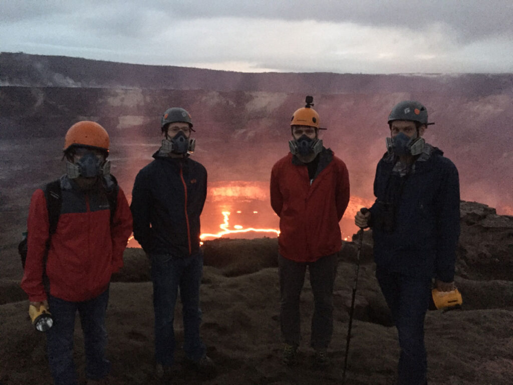A team of researchers stands in front of a lava lake in Hawaii’s Kīlauea volcano.