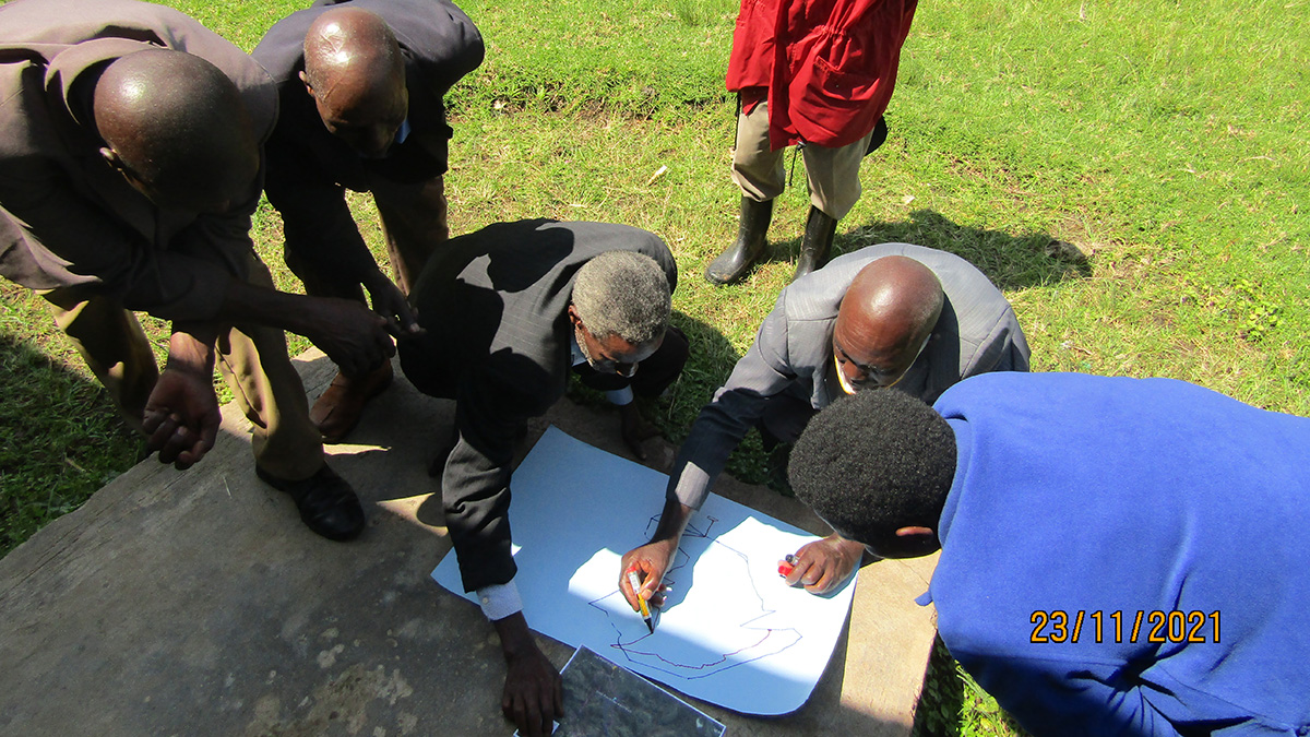 Senior citizens in a rural setting take part in a mapping workshop in Uganda’s Kigezi Highlands.