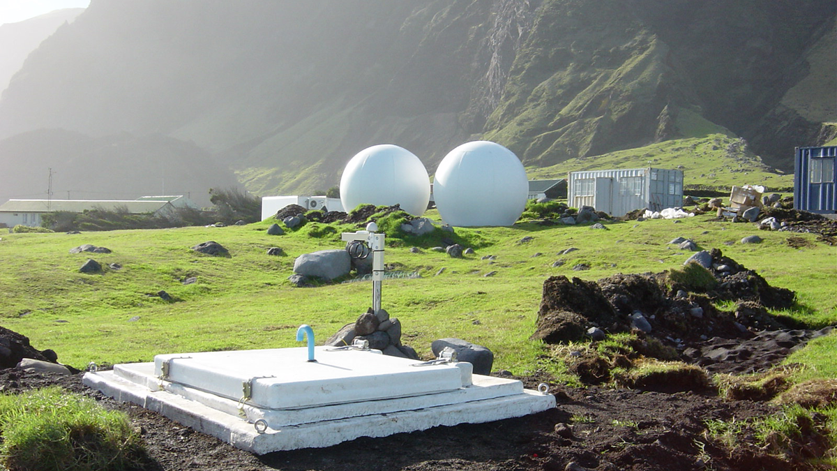 Photograph of a Global Seismographic Network station with mountains in the background.