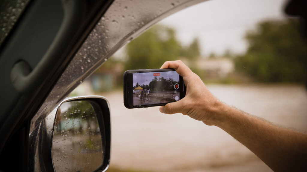 Documentation by mobile phone from inside a car of a flooded street and bridge after a heavy rainstorm in Dar es Salaam, Tanzania
