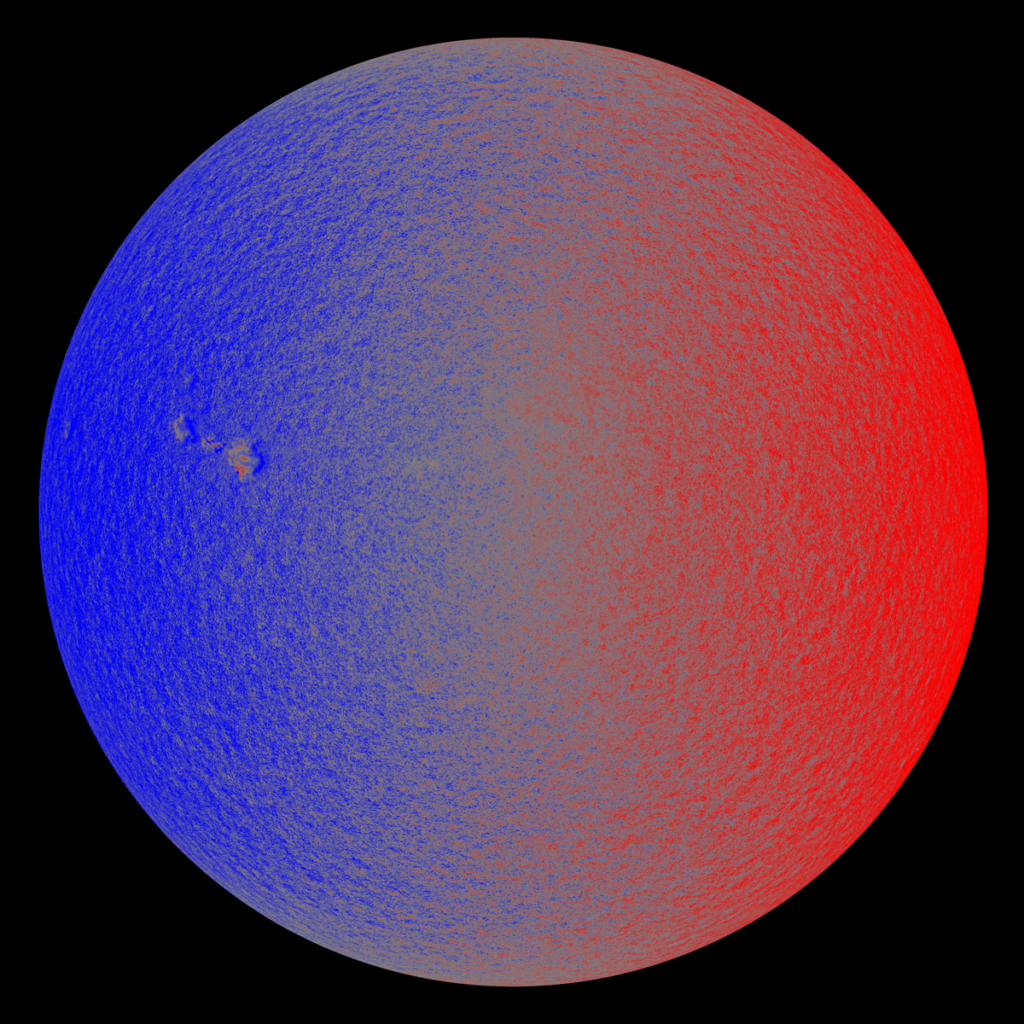 Image showing a full disk of the Sun, blue on left and red on right, indicating motions on the surface of the Sun.