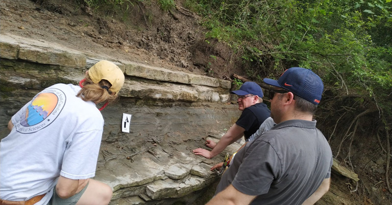 Linda Ivany, Christopher Junium, and James Witts examine the main K-Pg boundary deposit at Darting Minnow Creek, Brazos River, Texas.