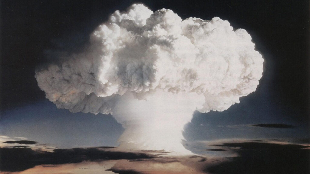 A distinctive mushroom cloud blossoms over the cloud line during detonation of the Ivy Mike hydrogen bomb in 1952.