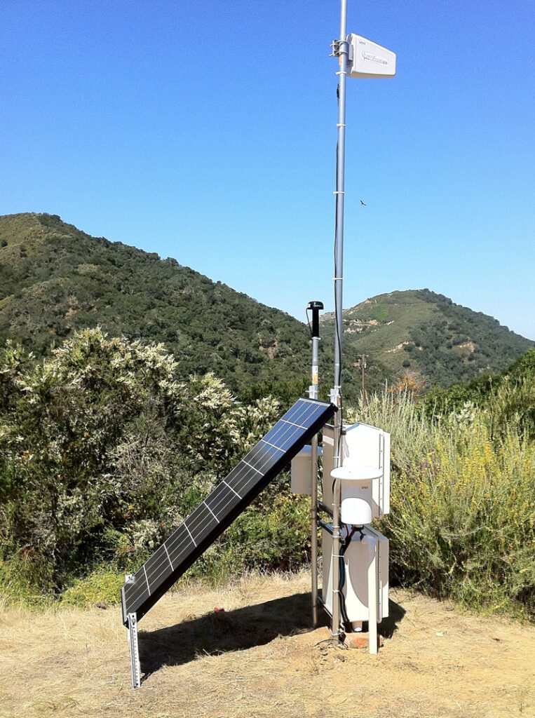 An instrument station with a solar panel installed on a mountain