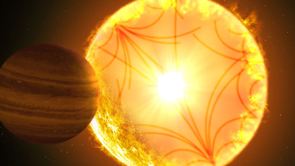 Artist’s illustration of a large yellow sphere with red curved lines running through it. A red striped sphere is in the foreground.